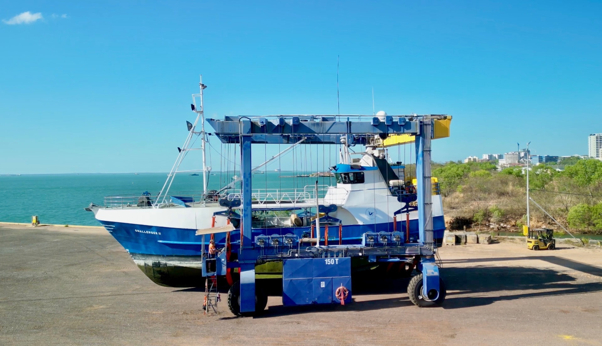 Travel lift moving a vessel over the lift dock at the North Coast Shiplift facility, Darwin